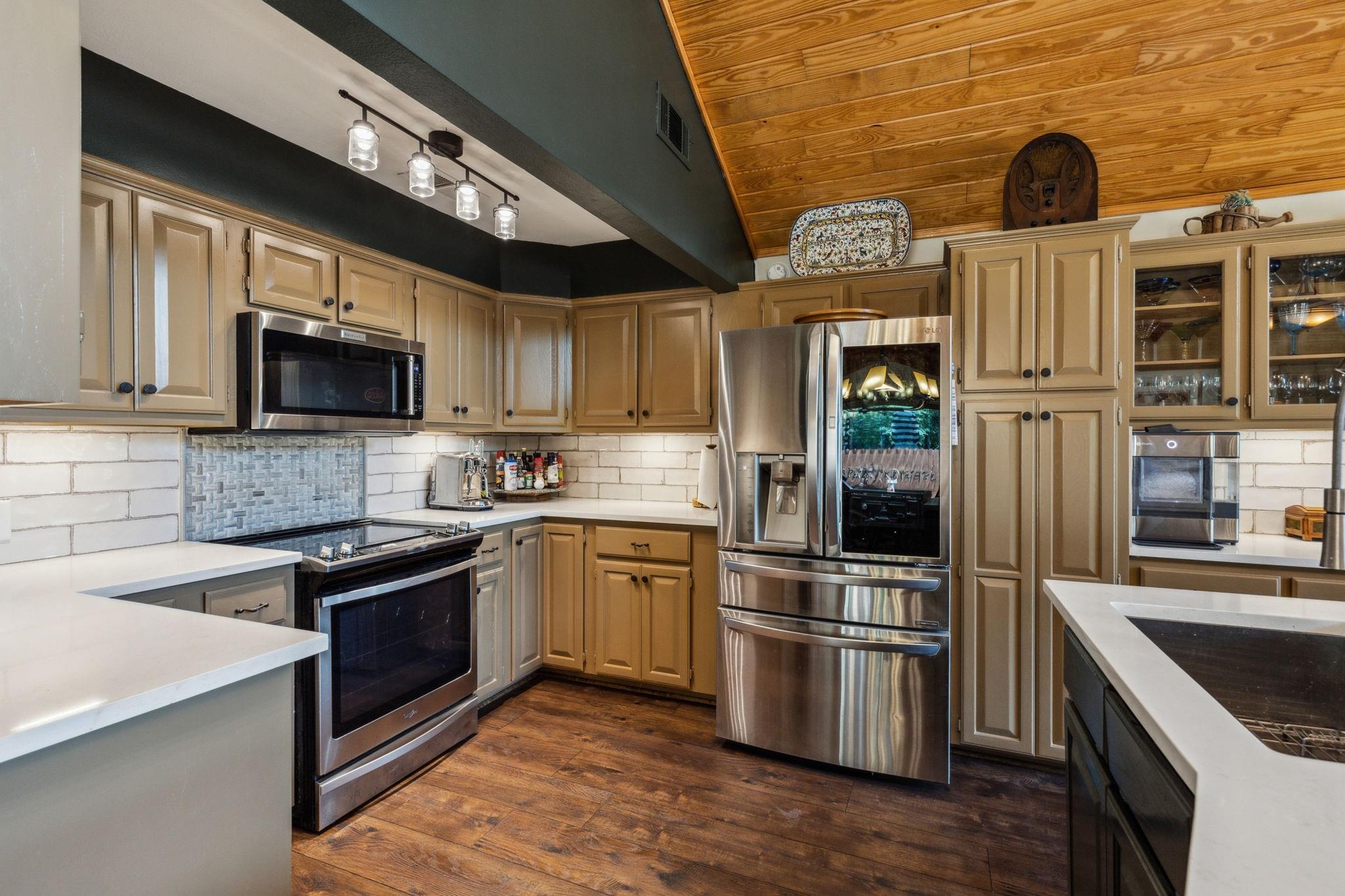 Full-size kitchen with French-door refrigerator and subway tile backsplash