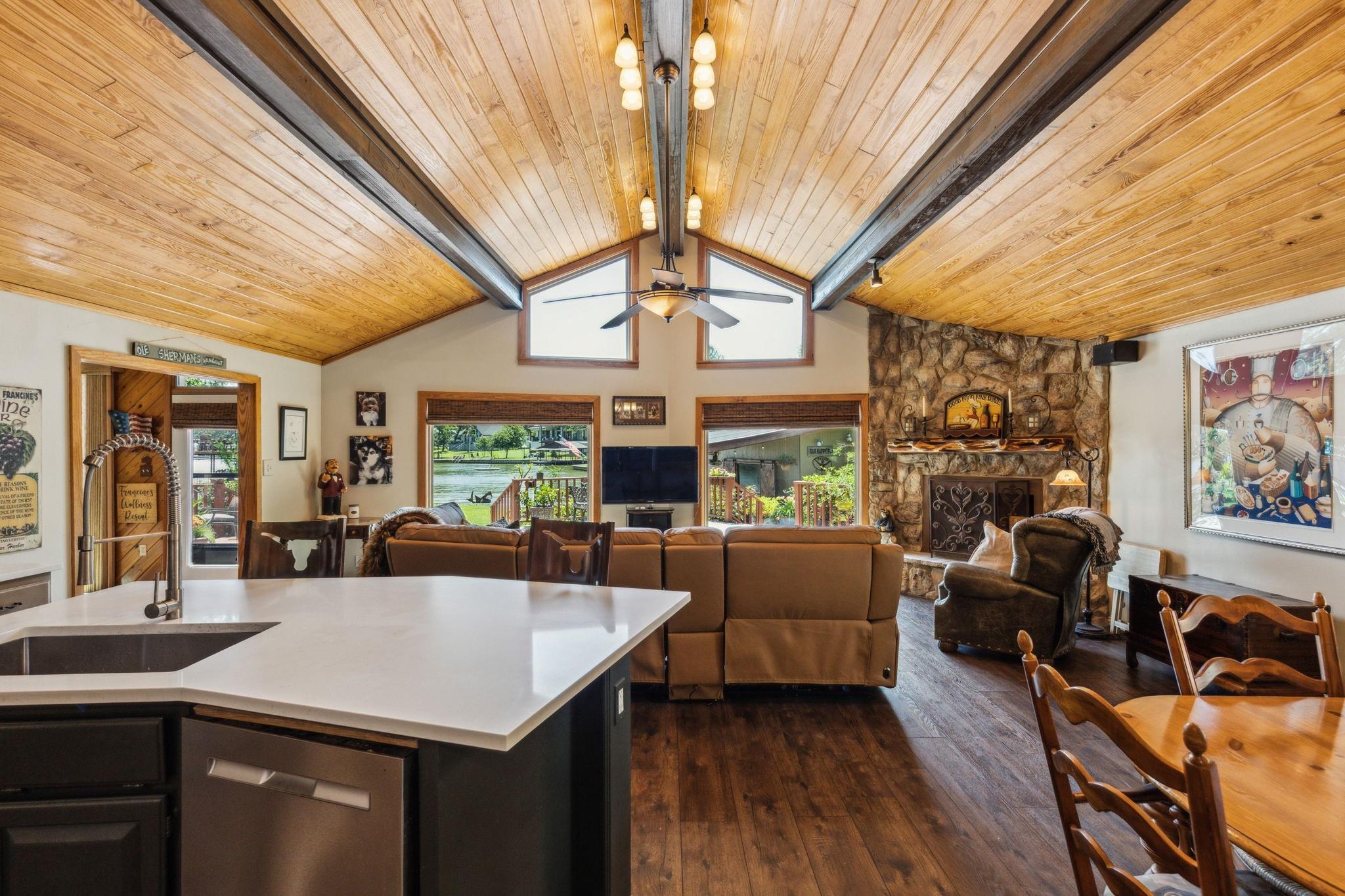 Open floor plan from kitchen island to living room with cathedral ceiling