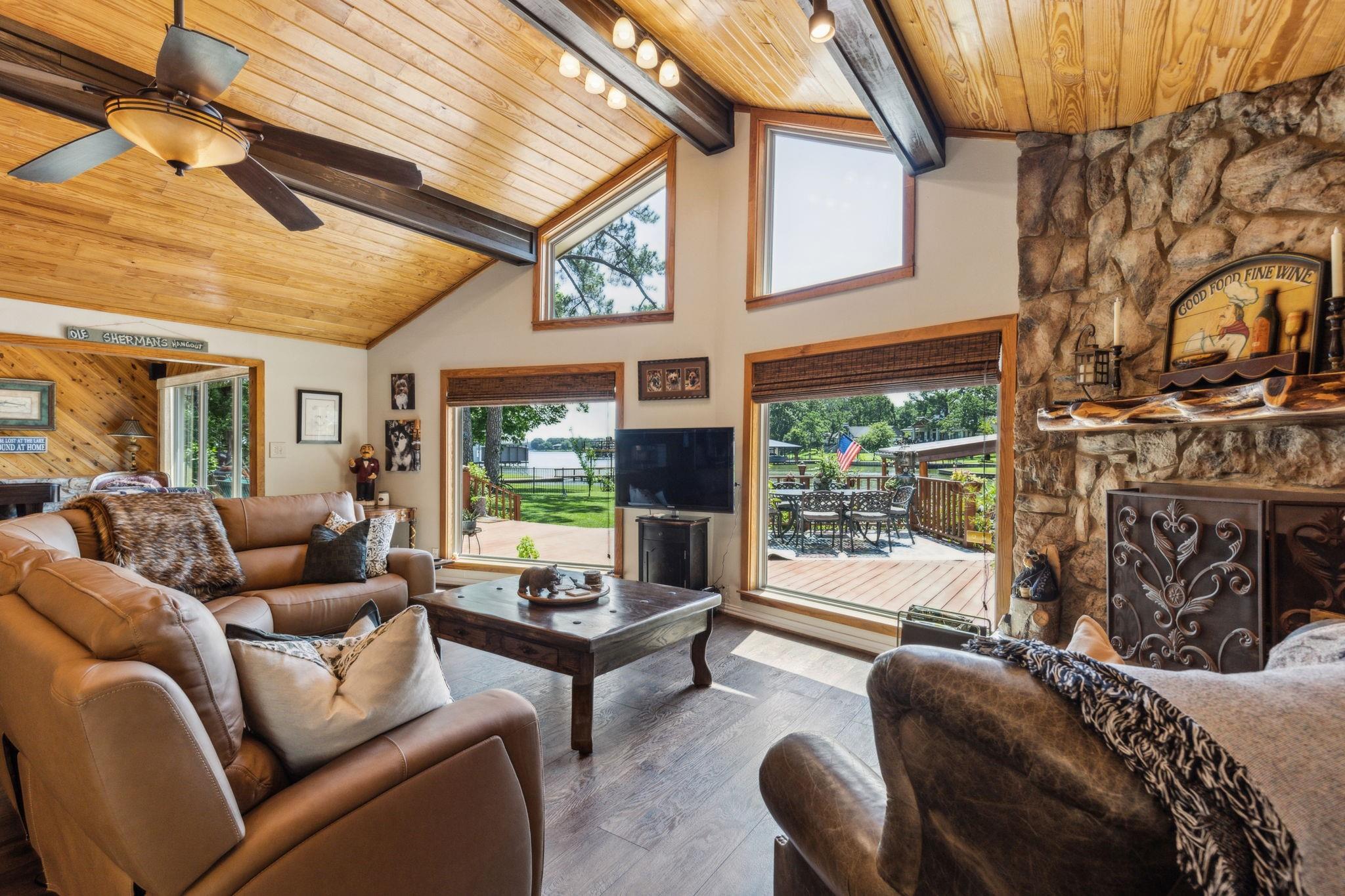 Living room with leather seating and lake views through picture windows